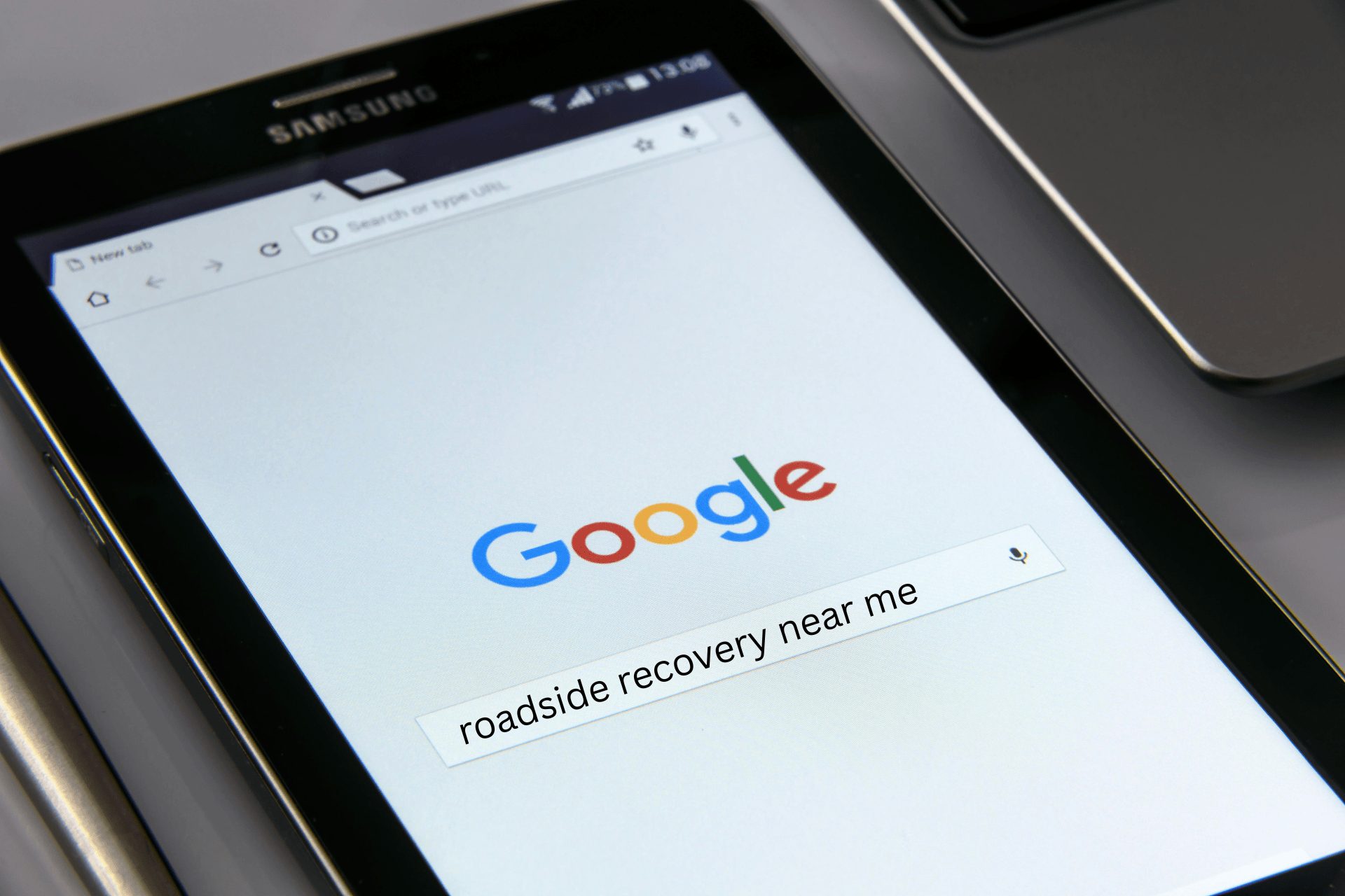 A Samsung tablet showing that someone has searched for roadside recovery near me on Google