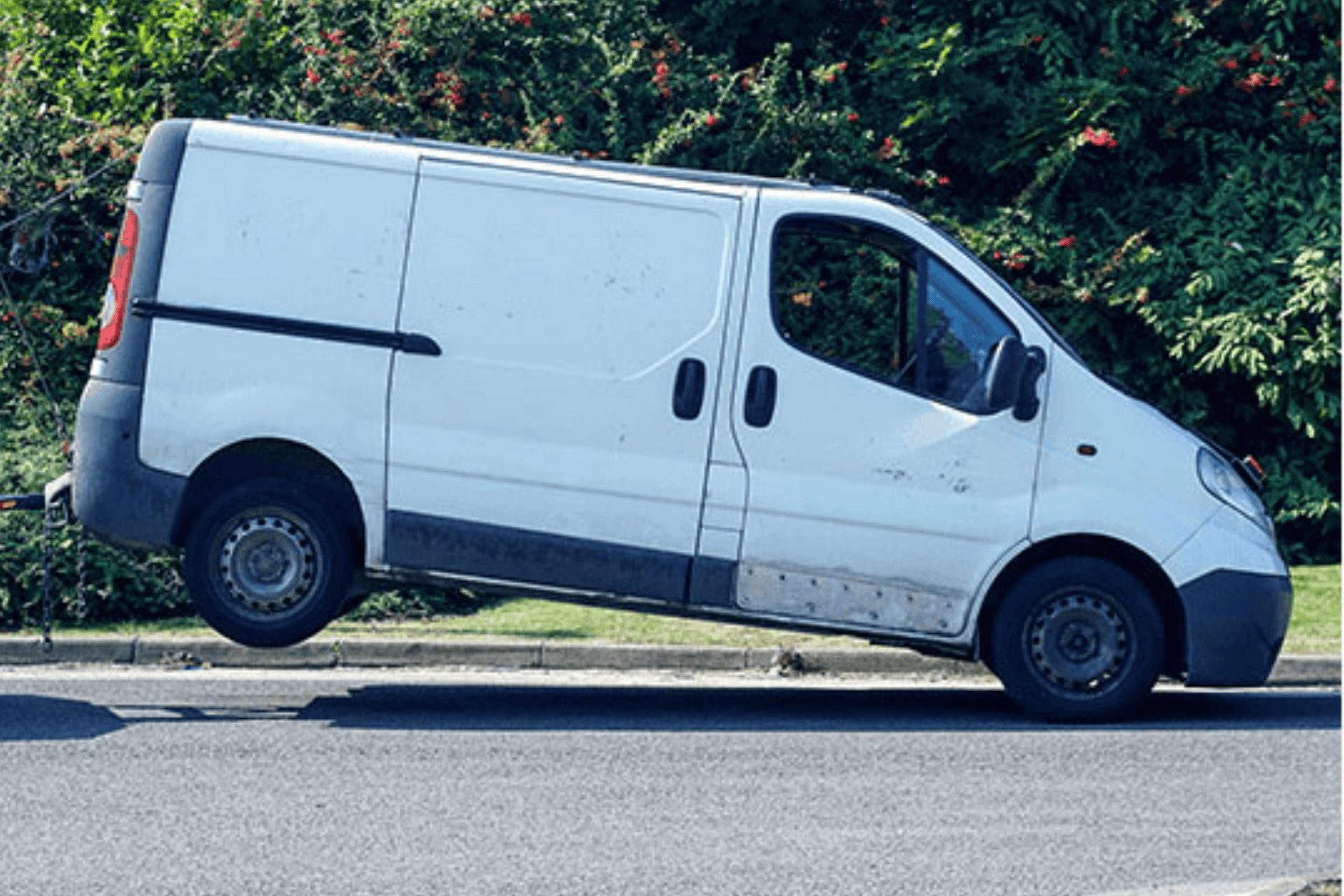 A white work van that has broken down and the driver has searched for recovery near me